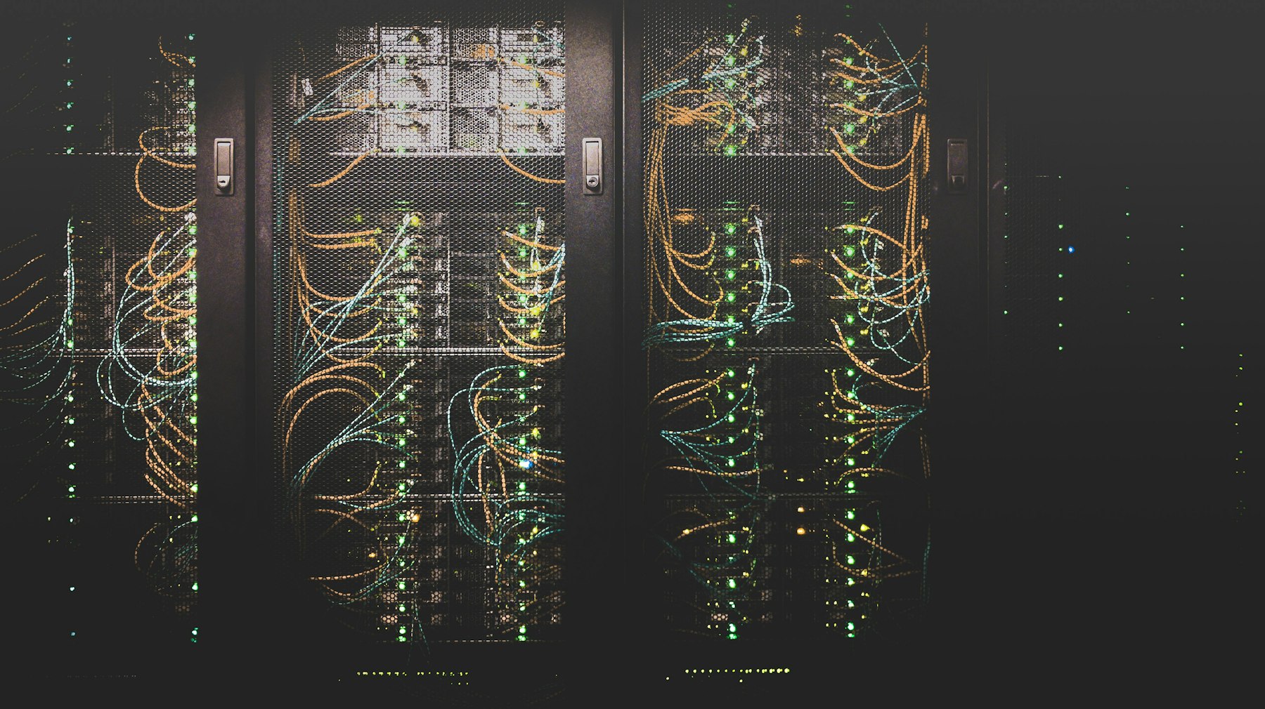 Dark data centre rack with patch cables and indicator lights